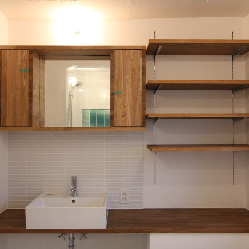 木製カウンターとミラー収納の洗面室