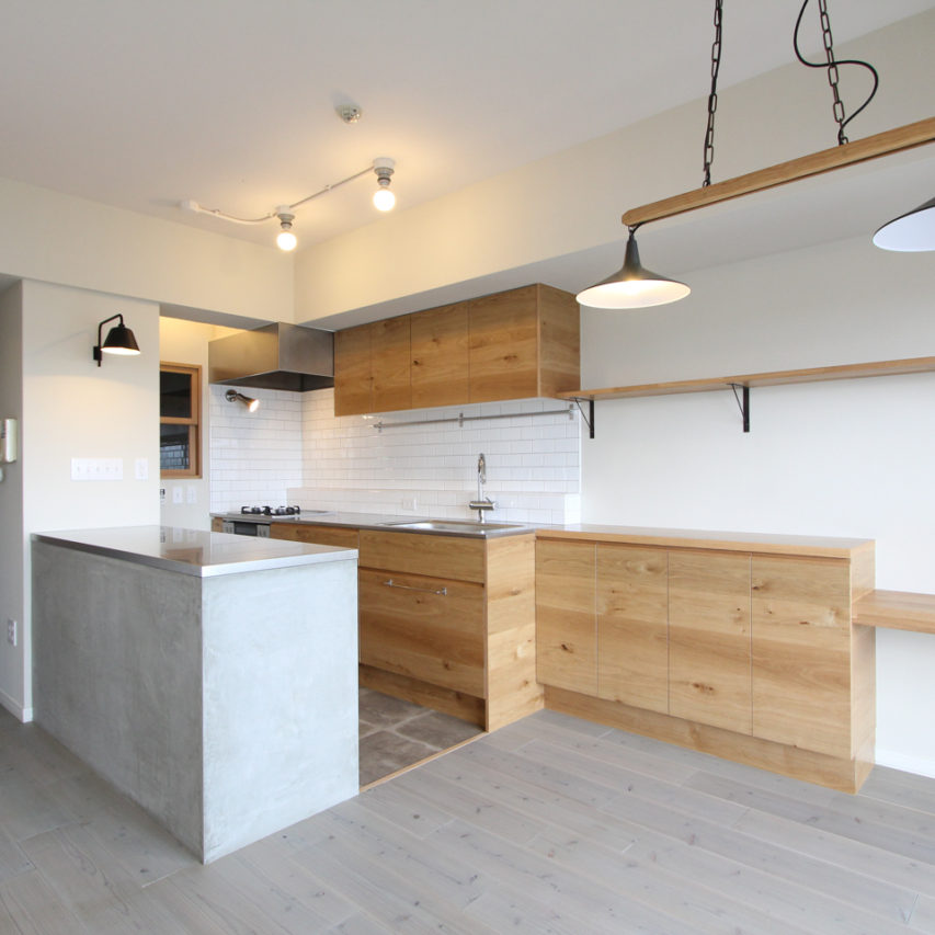 木製扉のオリジナルキッチンとモルタルの作業カウンター