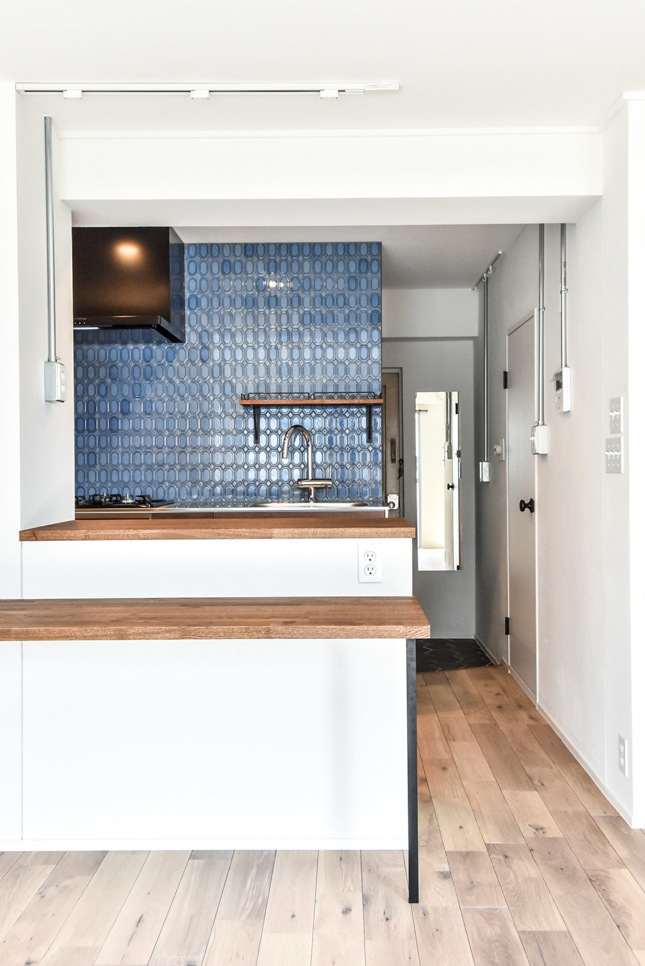 ブルーのタイルの壁のキッチンと木製のカウンター